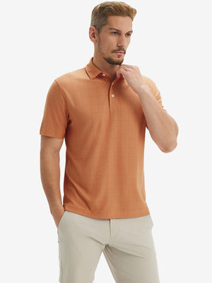 Front half body shot of model wearing orange adobe reflective performance reflective checked collar golf shirt