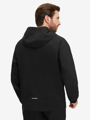 Back upper body shot of model wearing black waterproof lightweight rain jacket with hood