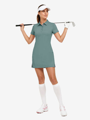 Front full body with golf club in dusty blue of women's lightweight golf dress with 2 pockets.