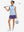Front full body shot of model with golf gear wearing dark purple women's gym golf shorts with liner pocket