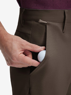 Detail view of front pocket on tobacco brown flat front hybrid golf shorts