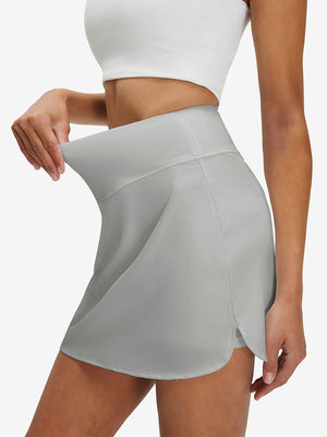 Detail view of elastic waistband on glacier grey high waist built-in short a-line golf skirt with 5 pockets