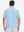 Back upper body shot of model wearing light blue dry fit waffle textured collared golf shirts