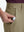 Detail view of front pocket on khaki flat front hybrid golf shorts