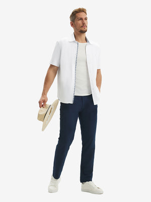 Front full body shot of model exercising in white cool print plain button up shirts