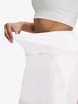 Detail view of side pocket on white women's stretch a-line golf skort with 7 pockets