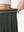 Detail view of elastic waistband on army green women's moisture-wicking athletic tennis skirts