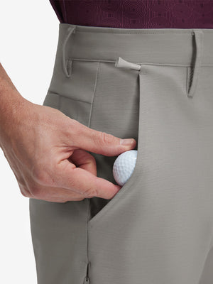 Detail view of front pocket on light gray flat front hybrid golf shorts