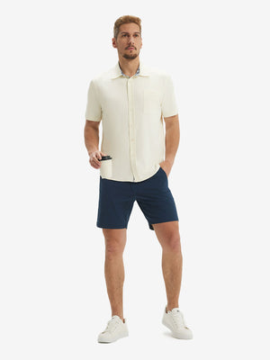 Front full body shot of model exercising in cream cool print plain button up shirts