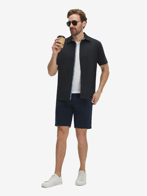 Front full body shot of model exercising in black cool print plain button up shirts