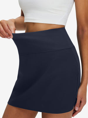 Detail view of elastic waistband on navy high waist built-in short a-line golf skirt with 5 pockets
