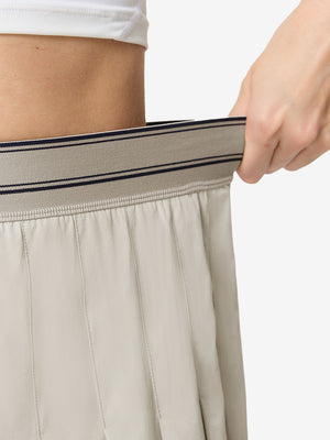 Detail view of elastic waistband on oyster gray women's moisture-wicking athletic tennis skirts