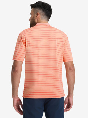 Back upper body shot of model wearing peach amber/calypso coral non-curl ribbed collar striped polo shirts
