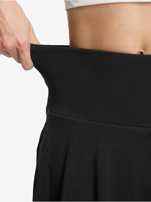 Detail view of skirt elasticity on black women's high waisted golf skirts with 4 inner pockets