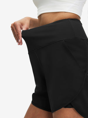Detail view of elastic waistband on black women's high waist 2 in 1 quick dry shorts with 7 pockets