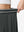 Detail view of elastic waistband on dark grey women's moisture-wicking athletic tennis skirts