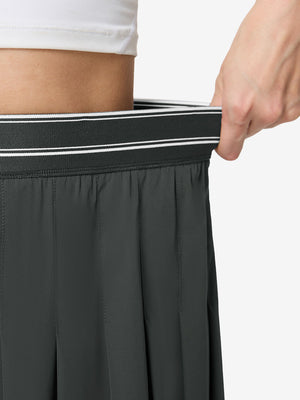 Detail view of elastic waistband on dark grey women's moisture-wicking athletic tennis skirts