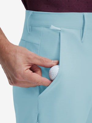 Detail view of front pocket on light blue flat front hybrid golf shorts