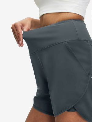 Detail view of elastic waistband on dark grey women's high waist 2 in 1 quick dry shorts with 7 pockets
