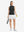 Front full body shot of model wearing black women's moisture-wicking mock neck sleeveless golf tops