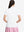 Back upper body shot of model wearing white women's 5 buttons collared polo shirts