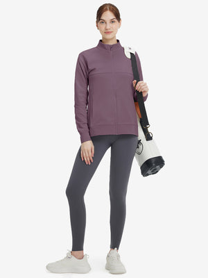 Women's Water-Resistant Stretch Fleece Lined Jacket in light pinkish purple, model holding golf club 