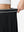 Detail view of elastic waistband on black women's moisture-wicking athletic tennis skirts