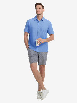 Full-body view of model holding takeaway drink cup in blue cotton blend plain shirt.