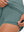 Inner side detail view in dusty blue of women's lightweight golf dress with 2 pockets.