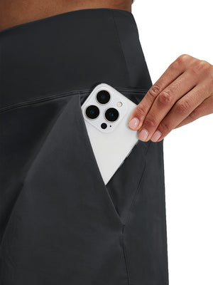Detail view of side pocket on black women's stretch a-line golf skort with 7 pockets