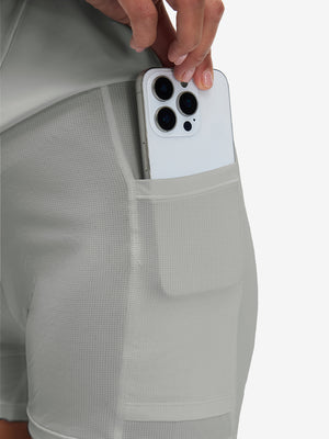 Side view of pocket on glacier grey high waist built-in short a-line golf skirt with 5 pockets
