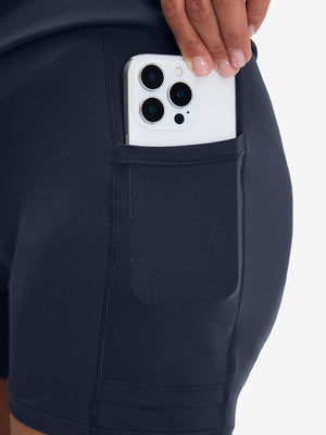 Side view of pocket on navy high waist built-in short a-line golf skirt with 5 pockets