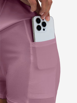 Side view of pocket on lavender pink high waist built-in short a-line golf skirt with 5 pockets