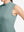 Detail view of armhole on dusty blue women's moisture-wicking mock neck sleeveless golf tops