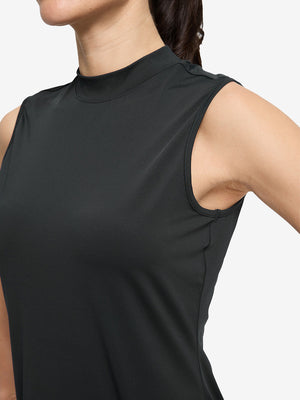 Detail view of armhole on black women's moisture-wicking mock neck sleeveless golf tops