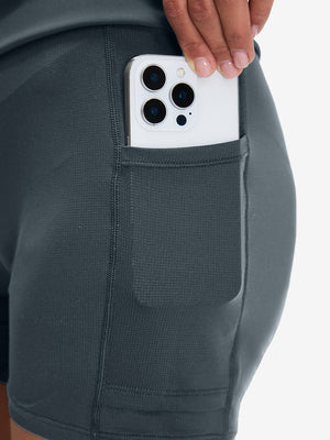 Side view of pocket on dark grey high waist built-in short a-line golf skirt with 5 pockets
