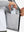 Hand placing an iPhone into pocket of water-resistant heat-tech softshell winter jacket with hood.