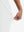 View showing loose fit of white women's high waist stretch golf pants with pockets