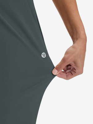View showing loose fit of dark grey women's high waist stretch golf pants with pockets
