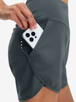 Side view of pocket on dark grey women's high waist 2 in 1 quick dry shorts with 7 pockets