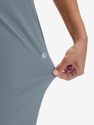 View showing loose fit of grey blue women's high waist stretch golf pants with pockets