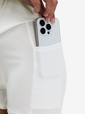Side view of pocket on white high waist built-in short a-line golf skirt with 5 pockets