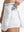 Detail view of inner pocket on white women's moisture-wicking athletic tennis skirts