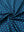 Close-up of four leaf clover performance jersey print polo fabric showing breathable texture.
