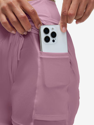 Inside view of pocket on lavender pink women's high waist 2 in 1 quick dry shorts with 7 pockets