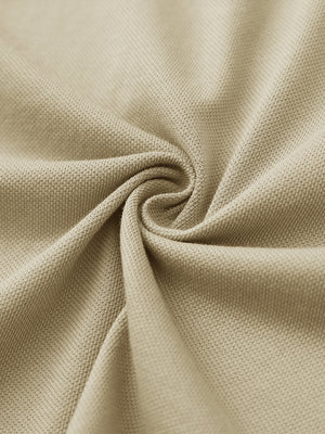 Fabric close-up of khaki cotton blend pique plain shirt, breathable pique fabric texture.