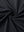 Close-up of black 4 way stretch jacquard polo fabric texture highlighting intricate woven pattern and elasticity.