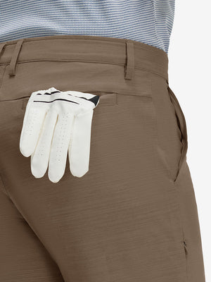Detail view of back pocket on tobacco brown straight fit lightweight dress golf pants