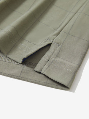Detail view of hem on birch grey grid performance reflective checked collar golf shirt