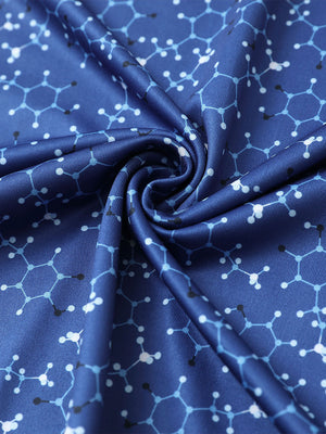 Close-up of blue molecular structure golf performance print boys golf polo fabric showing moisture-wicking texture 